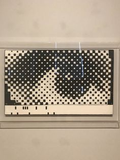 a piece of art that looks like it is made out of black and white squares