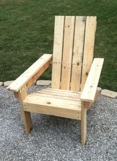 a wooden chair sitting on top of gravel