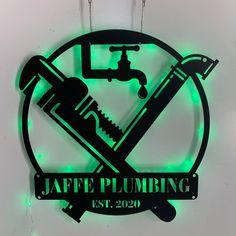 a green neon sign that says jaffe plumbing