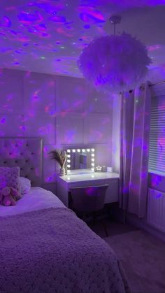 a bedroom decorated in purple and pink lights