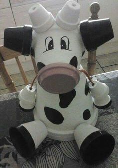 a fake cow sitting on top of a table