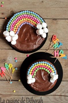 two cakes decorated with chocolate frosting and rainbow decorations