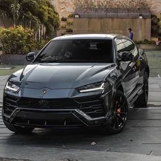 a black sports car parked in front of a building