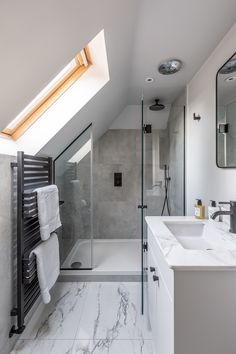 a bathroom with a skylight and marble counter tops