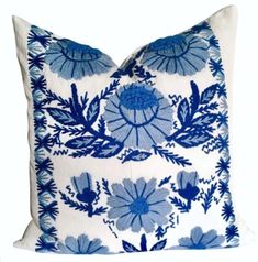 a blue and white pillow with flowers on it