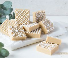 some cut out cookies sitting on top of a white plate next to a potted plant