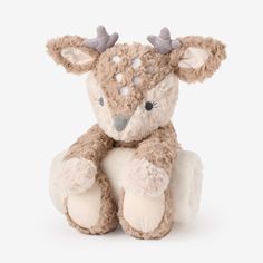 a small stuffed animal with horns on it's head and legs, sitting in front of a white background