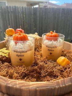 three pumpkin spice jars sitting on top of a wooden tray