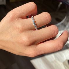 a woman's hand with a diamond ring on it