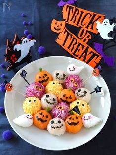 a white bowl filled with halloween treats on top of a table