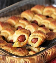 hotdogs wrapped in crescent rolls are sitting in a baking dish