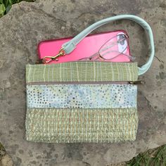 "Fresh Summer Color Mint Green Wristlet. Leather Strap,mixed with Batik and Industrial Quality Upholstery Fabric. The Front Pocket Fabric looks Handwoven! Large front zip pocket. Top zip opens to roomy interior. There's one inside pocket big enough for your credit cards. AND there's a clip off key ring It fits the largest phone. 7.5\" wide 4.75\" deep 1.25 bottom Use as your only bag, or use like a wallet and carry in a bigger bag. Great for an Evening bag , or when you want to carry only what y Leather Medicine Bag, Handbag Organizer, Bag Minimalist, Wrist Bag, Phone 7, Medicine Bag, Handbag Organization, Bag Summer, Organizer Bag