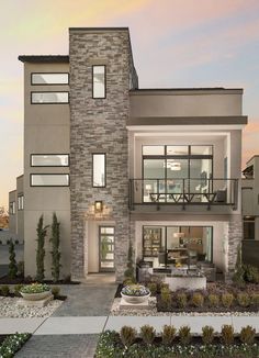 an exterior view of a two story house with landscaping in the front and side yard