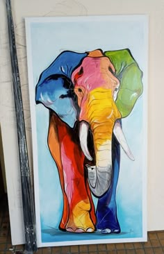 an elephant is painted in bright colors on the wall