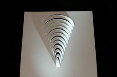 an abstract sculpture made out of white paper