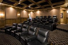 an empty theater with black leather seats