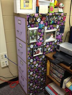 a refrigerator covered in pictures and magnets next to a desk with a computer on it