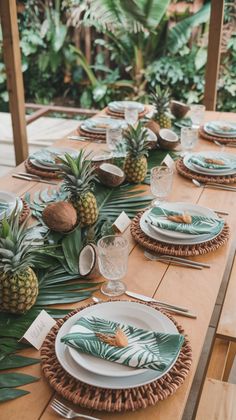 the table is set with pineapples and plates