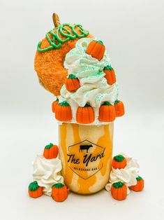 an ice cream sundae with pumpkins and whipped cream