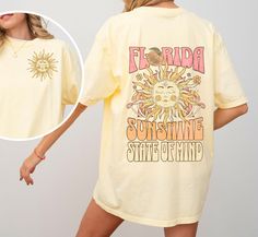 Bask in the endless summer vibes with our "Florida Sunshine State of Mind" shirt. This Comfort Colors tee captures the essence of Florida's radiant charm with a sun-kissed design on the front pocket, symbolizing the state's warm and inviting energy. Turn it around to reveal a vibrant back print. Whether you're strolling along the beach or lounging under the palm trees, this shirt is your perfect companion for soaking up the sun in true Floridian style.  * Q U I C K * F A C T S * ✺ The Comfort Colors 1717 tee is made with medium fabric consisting of high quality, 100% ring-spun US cotton for long-lasting comfort. ✺The relaxed fit, crew neckline. ✺The pre-shrunk fabric ensures a consistently great fit. ✺Made using 100% US cotton that is ethically grown and harvested.  ✺The unisex soft-style Pre-shrunk Graphic Tee For Summer, Yellow Summer T-shirt For Beach Season, Summer Vsco Style Tops With Funny Print, Summer Vsco Tops With Funny Print, Spring Vacation Shirt With Screen Print, Yellow Funny Print Shirt For Summer, Yellow Summer Shirt With Funny Print, Text Print Shirt For Spring And Summer, Summer Yellow Shirt With Funny Print