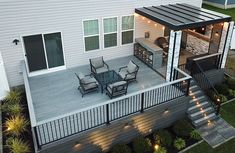 an aerial view of a deck with patio furniture and lights on the side of it