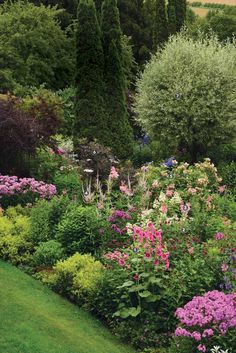 the garden is full of colorful flowers and trees