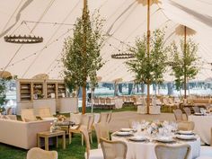 tables and chairs are set up in a large tent