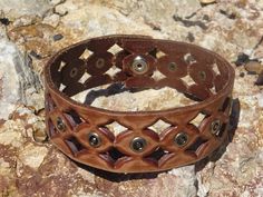 This choker is made from a upcycled leather belt.  This leather choker has a unique diamond punched design. This punched design is repeated along the length of the choker with silver studs added for visual intrest.  So fun!  The leather is brown but has the look of having been sanded to give it a rustic, used look. The choker closes at the back with a silver snap.  It will fit a 13.5 inch (34.25 cm) neck comfortably.  This would be a great gift.  This choker would look great on anybody! Choker m Unique Brown Choker For Festival, Unique Brown Festival Choker, Unique Adjustable Brown Choker, Choker Diamond, Yarn Necklace, Leather Wallet Pattern, Baby Necklace, Moroccan Art, Coin Art