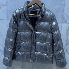 Size M Shiny Gray Puffer Jacket For Sale! ~Can Be Buttoned Or Zipped ~Never Worn/In Perfect Condition Accepting Offers Casual Silver Outerwear For Winter, Casual Silver Outerwear For Fall, Trendy Silver Outerwear For Fall, Casual Silver Winter Outerwear, Gray Down Puffer Outerwear, Urban Gray Long Sleeve Puffer Jacket, Silver Metallic Puffer Jacket Outfit, Gray Long Sleeve Puffer Jacket With Pockets, Gray Puffer Jacket