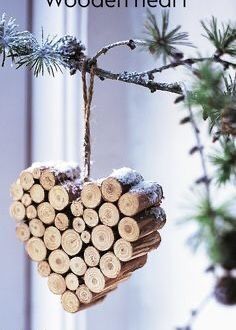 a heart shaped ornament hanging from a tree branch