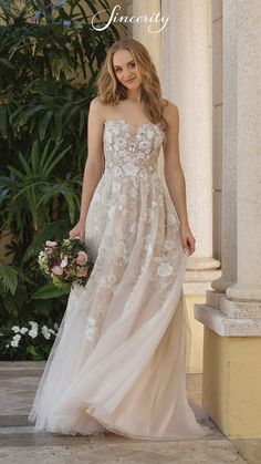 a woman in a wedding dress standing outside