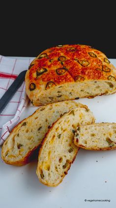 a loaf of bread sitting on top of a cutting board next to a knife and napkin