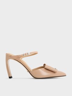 Channel your feminine side with these Lu mules. Decorative bows adorn the sharp pointed-toe silhouette, giving it a striking appeal that is hard to miss. In match-all nude, they can be styled easily with most outfits. Set on curved blade heels, they will elongate your frame, and pair perfectly with skirts and dresses. Skirts And Dresses, Heel Mules, Decorative Bows, Leather Bow, Charles Keith, Leather Bows, And Dresses, To Miss, Leather Heels