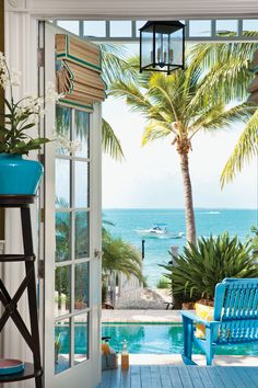 an open door leading to a pool and beach