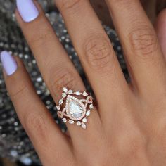 a woman's hand with a diamond ring on it