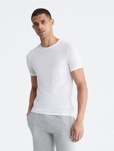 Sleep with ultrasoft comfort. The fitted, breathable design with added stretch is perfect for lounging and rest. Crafted from responsibly sourced modal, this Calvin Klein t-shirt features a crewneck, a fitted body and seaming details.  Material: 87% Modal, 13% Elastane. Basic Crew Neck Calvin Klein T-shirt, Basic Calvin Klein Crew Neck T-shirt, Classic Calvin Klein Short Sleeve T-shirt, Calvin Klein Relaxed Fit Crew Neck T-shirt, Classic Calvin Klein Crew Neck Top, Classic Calvin Klein Tops For Everyday, Modern Fitted Calvin Klein Top, Fitted Calvin Klein Crew Neck Top, Calvin Klein Modern Relaxed Fit Tops