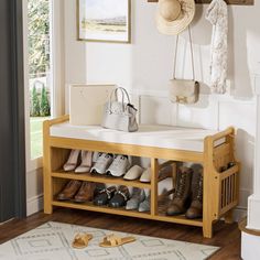 a wooden shoe rack with shoes and purses on it in front of a door