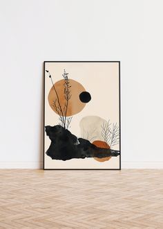 an abstract painting with black and orange colors on the wall in front of a wooden floor