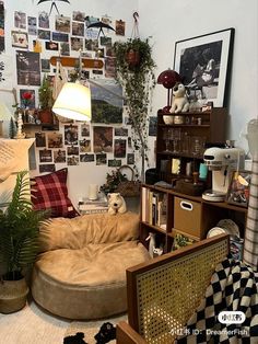 a living room filled with furniture and lots of pictures on the wall next to a lamp