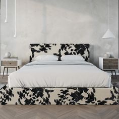 a bed with black and white flowers on it