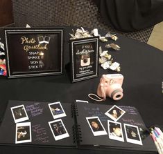 the table is set up with photos and other items for guests to take pictures on