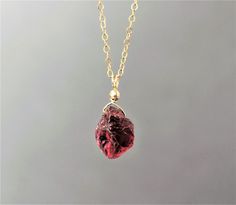 "- This listing is for one necklace. PHOTOS ARE ENLARGED. For the actual size, please refer to the last photo. - Made with small raw garnet gemstone with deep red color. The stone will not be exactly the same as shown in the pictures but very similar in size, color, and quality. If you have a certain shape or preference in stone, please specify during checkout in \"note to seller\" section. I'll send you photos as I fill your order. Thank you! The garnet is in small size. The length is around 10 Red Crystal Gemstone Necklace For Gifts, Red Crystal Necklace With Gemstone For Gift, Red Crystal Necklace With Natural Stones For Gift, Burgundy Garnet Necklaces For Gifts, Ruby Necklace With Natural Stones As A Gift, Ruby Necklace With Natural Stones For Gift, Burgundy Ruby Necklace As Gift, Burgundy Ruby Necklace For A Gift, Handmade Burgundy Necklace As Gift