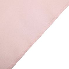 a pink sheet that is laying on top of a bed