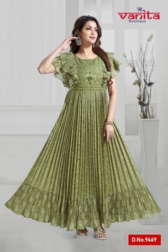 A full-length green kurti designed for special occasions. This Anarkali-style kurti is meticulously tailored in chinnon fabric, creating a crushed finish. The yoke portion is subtly accentuated with thread embroidery, and ruffle sleeves add a stunning touch. The skirt portion has a flowing appearance with delicate pleats. The kurti is embellished with scattered zari buttis, giving it an elegant party-ready finish. The border imparts a festive look to the attire.  Note: Colors may slightly vary d Designer Ruffled Dresses For Eid, Designer Green Dress With Ruffles, Anarkali Dress With Ruffles For Designer Wear, Festive Ruffled Maxi Dress, Festive Maxi Dress With Ruffles, Green Anarkali Set For Spring Festival, Bollywood Ruffle Dress For Eid, Spring Festive Green Anarkali Set, Maxi Length Green Kurta For Eid