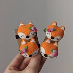 two small stuffed animals in the palm of someone's hand