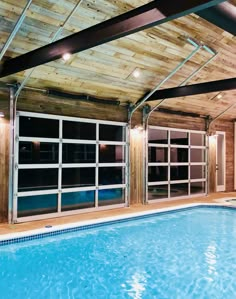 an indoor swimming pool with glass doors