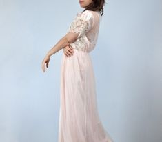 Vintage 1970s-80s peignoir set. Nylon fabric with lace panelling in the prettiest pale pink. ✈ Measurements ✈ * Taken from SEAM to SEAM with garment lying flat * . . . ROBE . . . Bust * 22" Sleeve * 3" Waist * 10 - 19" Hips * 25" Length * 62" . . . NIGHTGOWN . . . Bust * Free Size Waist * 11 - 18" Hips * 25" Length (from empire waist to hem) * 43.5"  ✈ Specifics ✈ Label: UndercoverWear, made in USA Tagged Size: XL Approx. Fit: Medium to Large Color: Pale pink, off-white Material: 100% Nylon Cond Pink Feminine Sleepwear For Wedding, Feminine Pink Sleepwear For Wedding, Pink Feminine Sleepwear For Evening, Feminine Pink Sleepwear For Evening, Wedding Sheer Pink Nightgown, Spring Wedding Pink Nightgown, Vintage Pink Sleepwear For Wedding, Vintage Pink Wedding Sleepwear, Pink Lace Trim Sleepwear For Evening