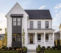 a white house with black shutters on the front