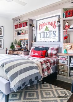 a bedroom decorated for christmas with red, white and green decorations on the shelves above the bed