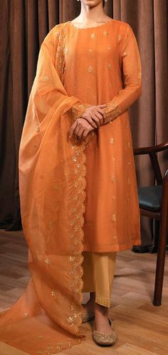 "Material: High-quality net fabric Design: long net shirt and dupatta Color Options: orange Occasion: Ideal for weddings, parties, or cultural events Features: Ready to wear, no hassle of stitching Comfortable and easy to wear Exquisite craftsmanship Care Instructions: Dry clean only for long-lasting beauty and durability. the color of the product in the photo might look slightly different in person due to factors like lighting and screen settings.\" \"Please note that sizes may vary based on the specific style of the item.\"" Orange Organza Sharara For Festivals, Semi-stitched Orange Salwar Kameez With Zari Work, Semi-stitched Orange Churidar With Zari Work, Designer Orange Dupatta For Festivals, Designer Orange Dupatta With Resham Embroidery, Designer Festival Orange Dupatta, Festival Orange Organza Sharara, Semi-stitched Orange Sharara With Dabka Details, Semi-stitched Orange Chanderi Salwar Kameez